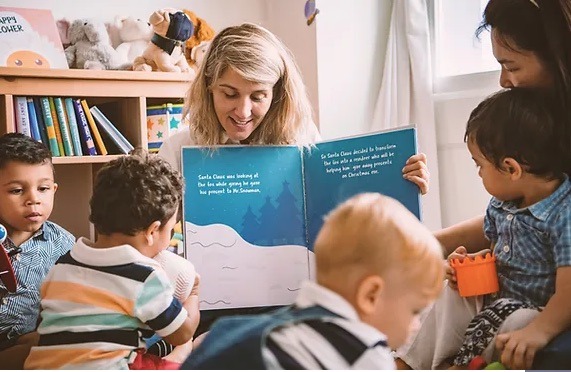 Image of children with teacher reading